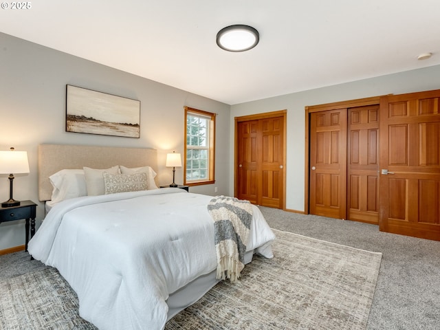 carpeted bedroom featuring multiple closets