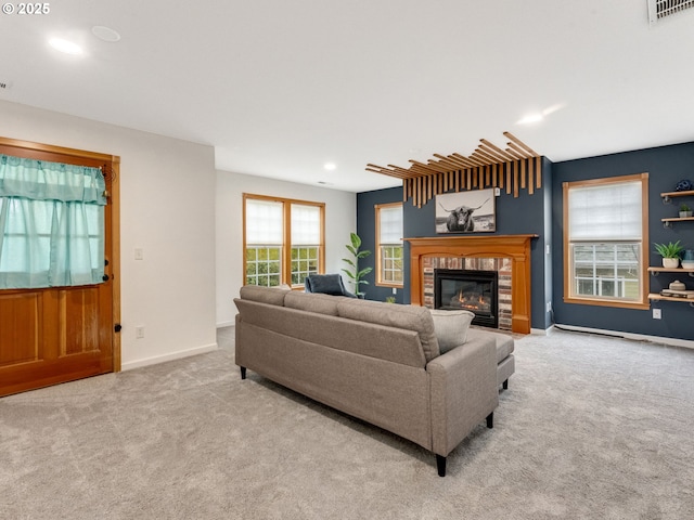 living room with light carpet and a fireplace