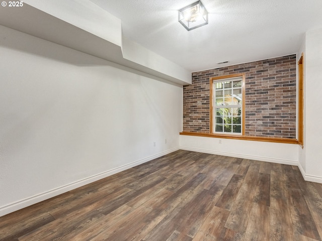 unfurnished room with dark hardwood / wood-style flooring