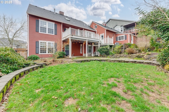 rear view of house with a patio area and a lawn