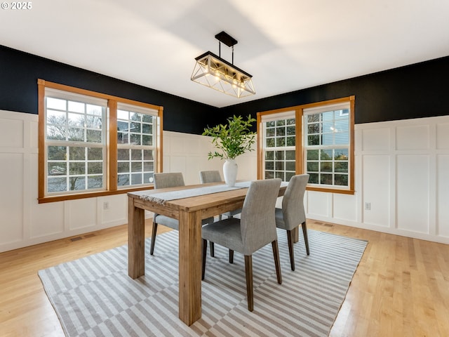 dining space with light hardwood / wood-style floors