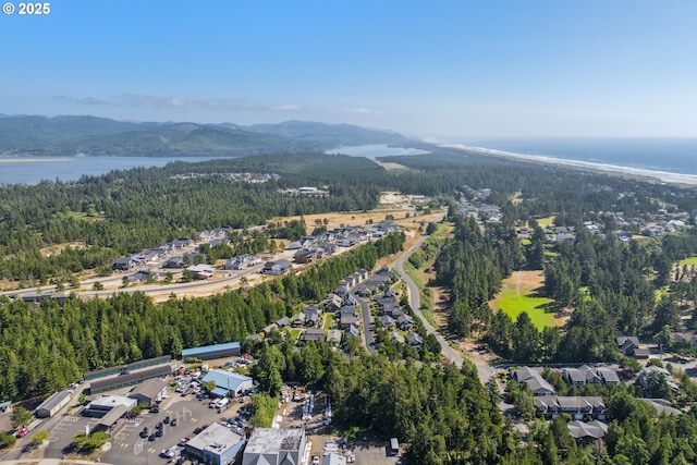 559 Meadows Dr, Manzanita, OR 97130 - aerial overview of property's location featuring a water and mountain view, a heavily wooded area, and nearby suburban area
