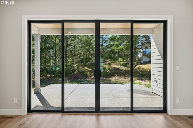 559 Meadows Dr, Manzanita, OR 97130 - doorway to outside featuring baseboards and wood finished floors
