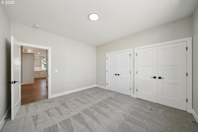 559 Meadows Dr, Manzanita, OR 97130 - unfurnished bedroom with carpet, multiple closets, and baseboards