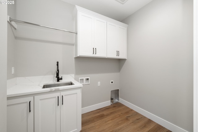 559 Meadows Dr, Manzanita, OR 97130 - washroom featuring cabinet space, hookup for an electric dryer, hookup for a washing machine, light wood-style floors, and baseboards