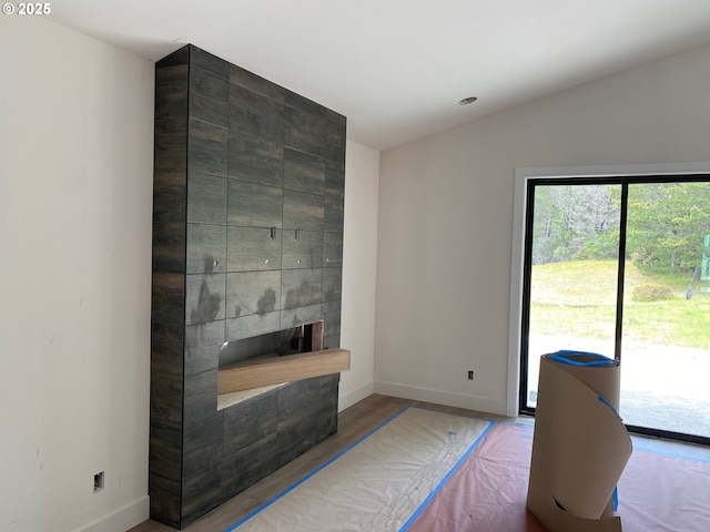 559 Meadows Dr, Manzanita, OR 97130 - living room with a large fireplace, baseboards, wood finished floors, lofted ceiling, and recessed lighting