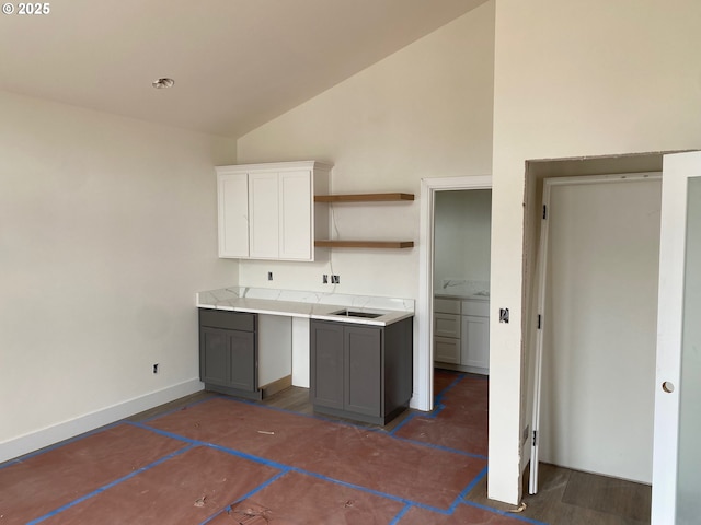 559 Meadows Dr, Manzanita, OR 97130 - kitchen with open shelves, gray cabinetry, light countertops, white cabinets, and high vaulted ceiling