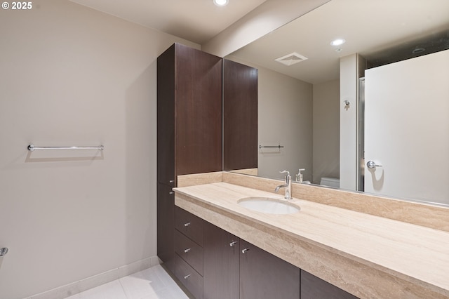 1930 S River Dr Unit W504, Portland, OR 97201 - bathroom featuring tile patterned floors, toilet, baseboards, vanity, and recessed lighting