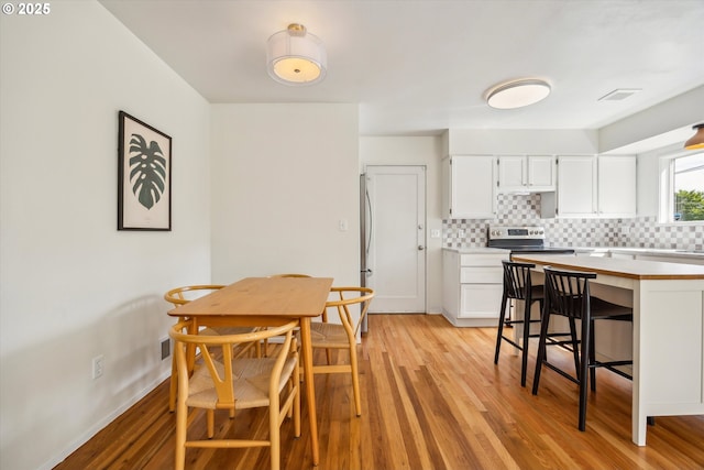 5515 SE 62nd Ave, Portland, OR 97206 - dining room featuring light wood-style floors and baseboards