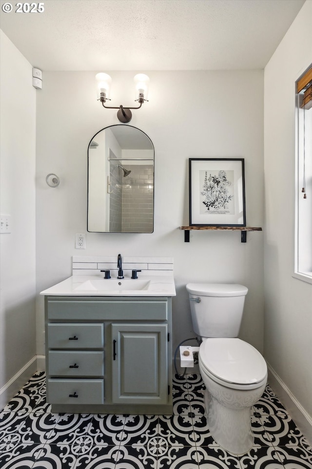 5515 SE 62nd Ave, Portland, OR 97206 - bathroom featuring baseboards, vanity, toilet, and a tile shower
