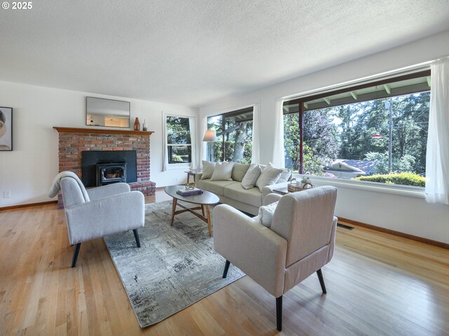 3290 Fillmore St, Eugene, OR 97405 - living area with wood finished floors, a textured ceiling, and a fireplace