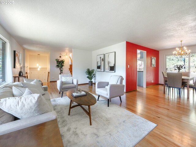 3290 Fillmore St, Eugene, OR 97405 - living room with a chandelier, a textured ceiling, and light wood-style floors