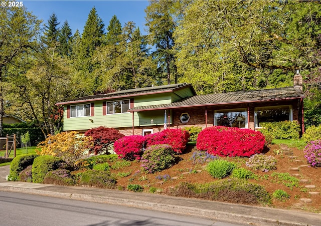 3290 Fillmore St, Eugene, OR 97405 - view of front facade featuring a standing seam roof, a metal roof, and stone siding