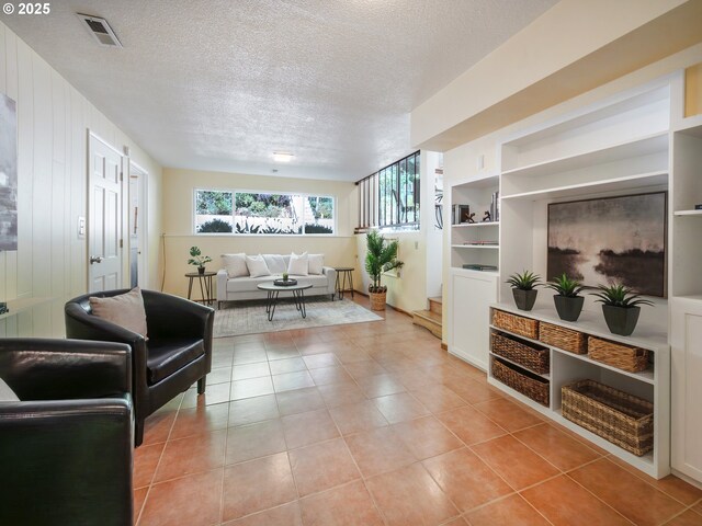3290 Fillmore St, Eugene, OR 97405 - living room with light tile patterned floors, a textured ceiling, and built in features