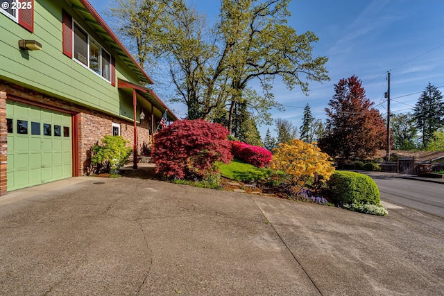 3290 Fillmore St, Eugene, OR 97405 - view of side of property featuring asphalt driveway, an attached garage, and brick siding