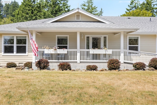 95245 N Bank Rogue River Rd, Gold Beach, OR 97444 - view of front of home featuring roof with shingles, covered porch, and a front lawn