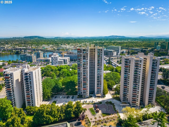 drone / aerial view with a water and mountain view and a city view