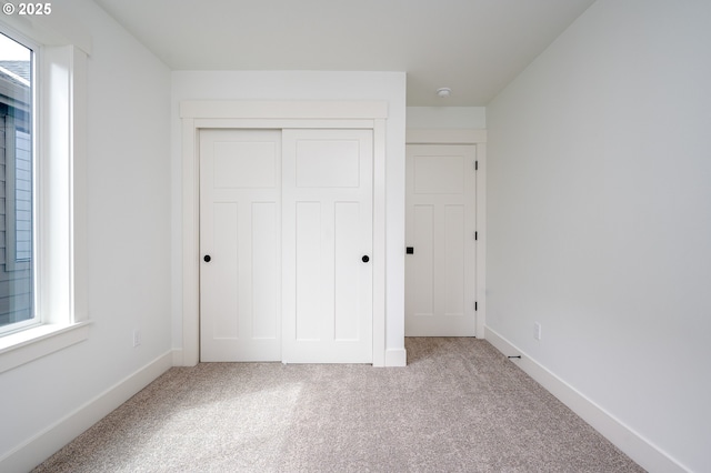 5827 NE 16th Ave, Portland, OR 97211 - unfurnished bedroom with carpet floors, a closet, and baseboards