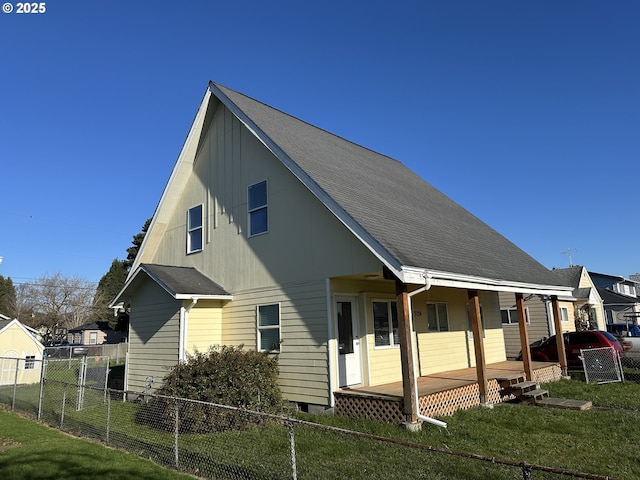 view of side of property with a lawn and a porch