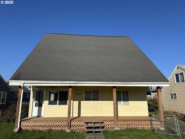 rear view of property with a porch