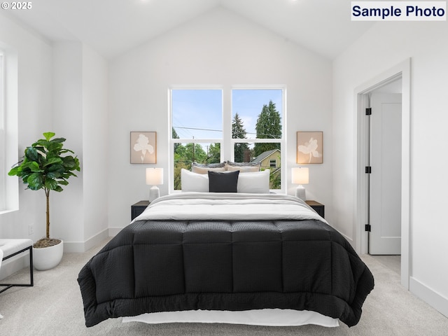 bedroom featuring vaulted ceiling, baseboards, and carpet flooring
