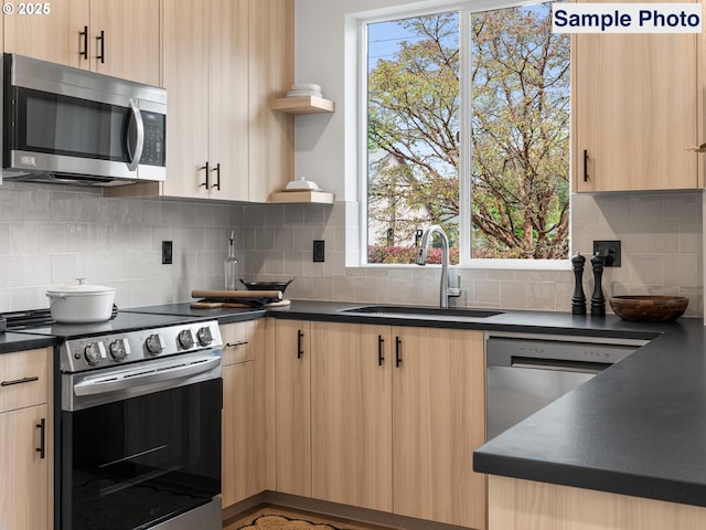 kitchen with open shelves, appliances with stainless steel finishes, a sink, and light brown cabinets