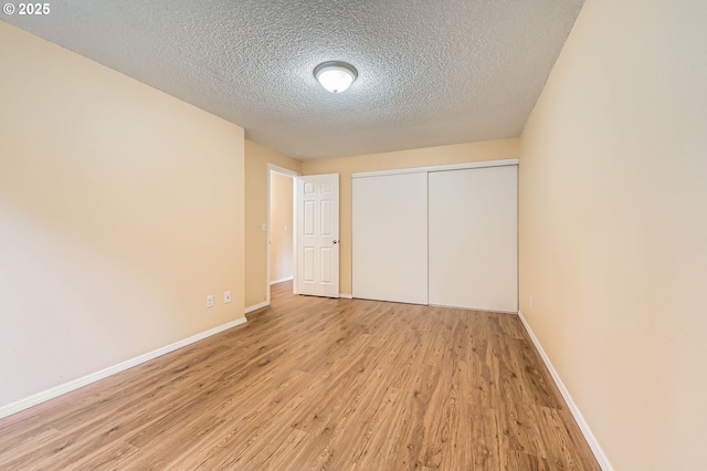 12172 SE Beckman Ave, Milwaukie, OR 97222 - unfurnished bedroom with light wood-style flooring, a textured ceiling, and a closet