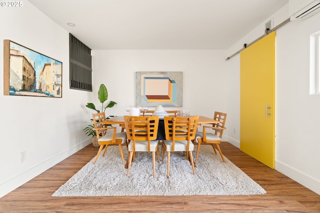 1368 Boca Ratan Dr, Lake Oswego, OR 97034 - dining space with a barn door, wood finished floors, and an AC wall unit
