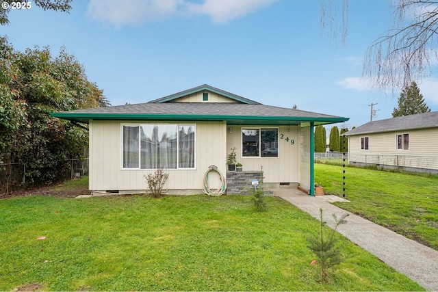 bungalow with crawl space, a shingled roof, a front yard, and fence