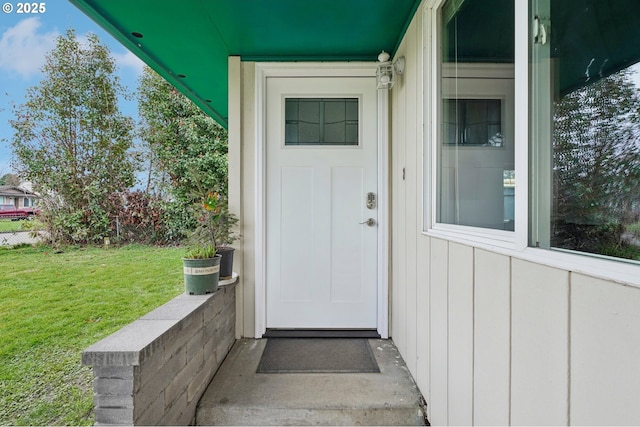 entrance to property with a yard and board and batten siding