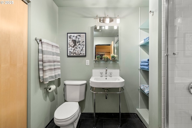 bathroom with tile patterned floors, toilet, sink, and a shower