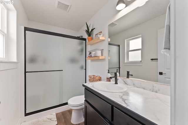 1410 NW Keasey St, Roseburg, OR 97471 - full bath with vanity, toilet, a shower stall, and wood finished floors