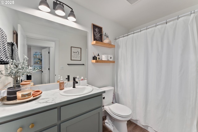 1410 NW Keasey St, Roseburg, OR 97471 - bathroom featuring vanity, toilet, wood finished floors, and a shower with shower curtain
