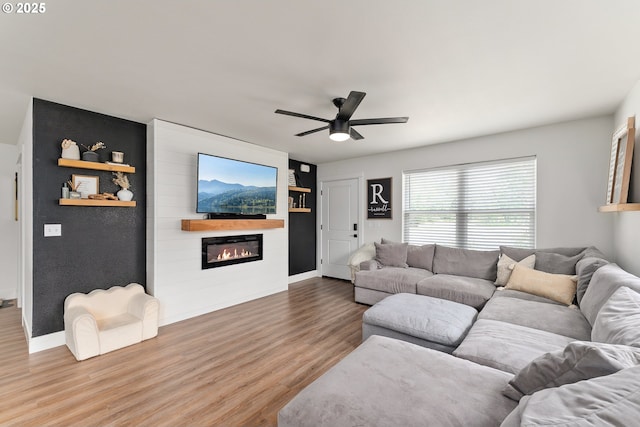 1410 NW Keasey St, Roseburg, OR 97471 - living area featuring a ceiling fan, wood finished floors, a fireplace, and baseboards