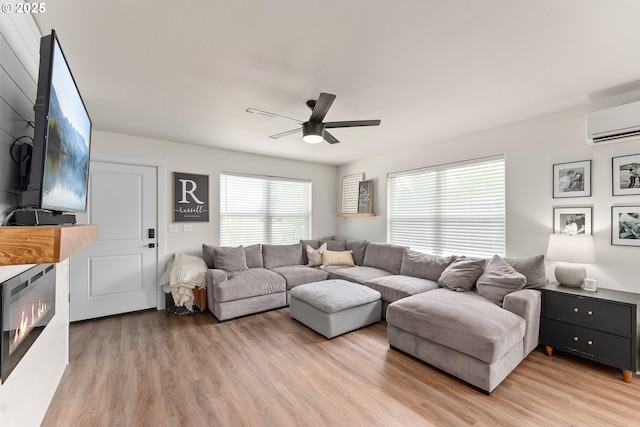 1410 NW Keasey St, Roseburg, OR 97471 - living room with ceiling fan, an AC wall unit, and light wood-style flooring