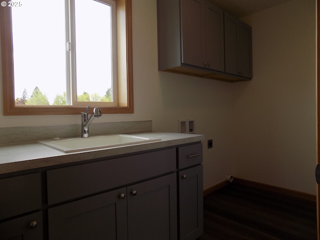 545 SE Firefly Ave, Corvallis, OR 97333 - laundry area featuring hookup for an electric dryer, washer hookup, cabinet space, dark wood finished floors, and baseboards