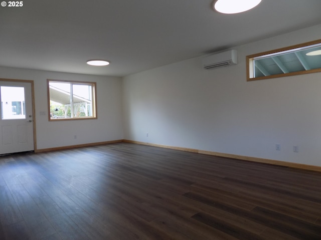 545 SE Firefly Ave, Corvallis, OR 97333 - empty room featuring a wall mounted AC, dark wood finished floors, and baseboards