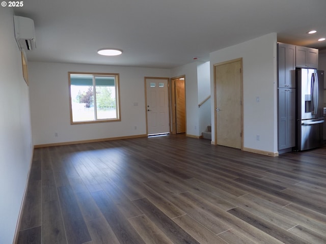 545 SE Firefly Ave, Corvallis, OR 97333 - unfurnished living room with a wall unit AC, baseboards, stairs, recessed lighting, and dark wood-style flooring