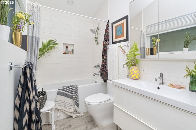7228 N Villard Ave, Portland, OR 97217 - bathroom featuring vanity, shower / tub combo with curtain, backsplash, and wood finished floors