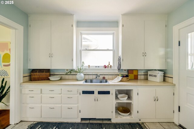 7228 N Villard Ave, Portland, OR 97217 - kitchen with light tile patterned flooring, light countertops, and white cabinetry