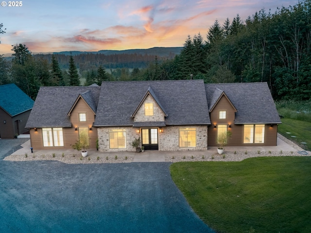 215 Cowlitz Vista Rd, Toledo, WA 98591 - view of front of home featuring a front lawn, stone siding, a mountain view, and roof with shingles