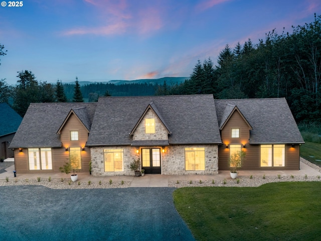 215 Cowlitz Vista Rd, Toledo, WA 98591 - view of front of property with french doors, stone siding, a front yard, and roof with shingles