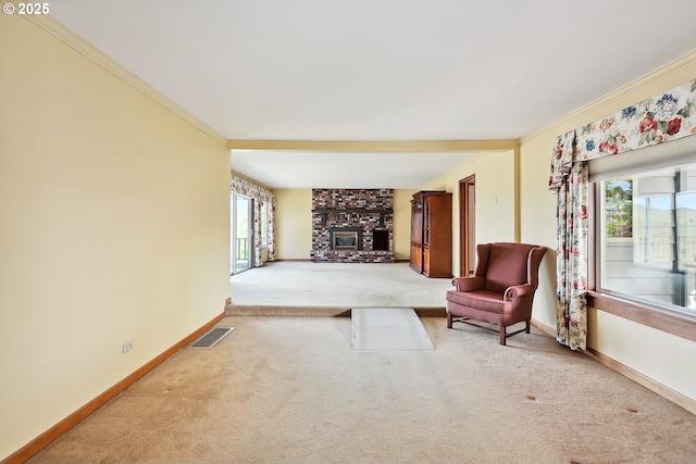 carpeted living room with baseboards, visible vents, ornamental molding, and a healthy amount of sunlight