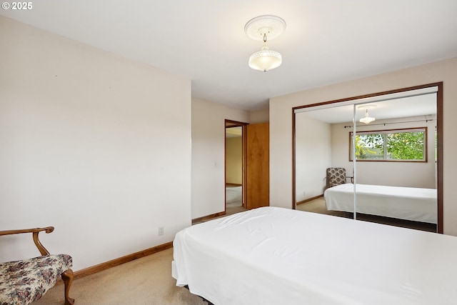 bedroom with carpet flooring, baseboards, and a closet