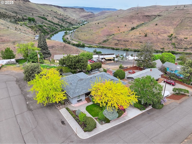 bird's eye view with a water and mountain view