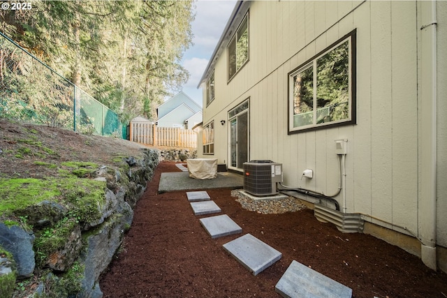 view of yard featuring central AC and a patio area