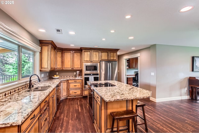 10588 Crosby Rd NE, Woodburn, OR 97071 - kitchen with a sink, appliances with stainless steel finishes, dark wood-style flooring, a kitchen island with sink, and recessed lighting