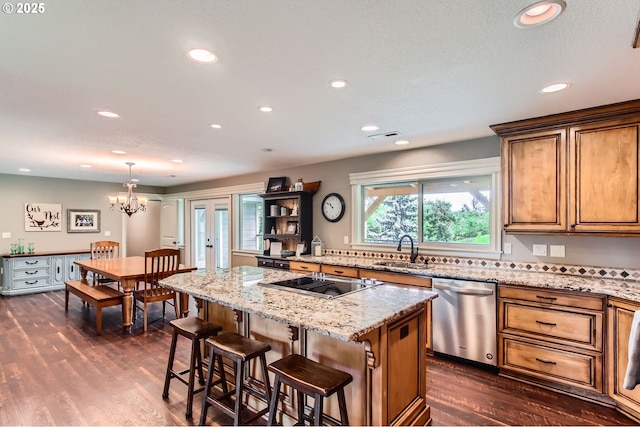 10588 Crosby Rd NE, Woodburn, OR 97071 - kitchen featuring dishwasher, black electric cooktop, a sink, brown cabinets, and dark wood finished floors