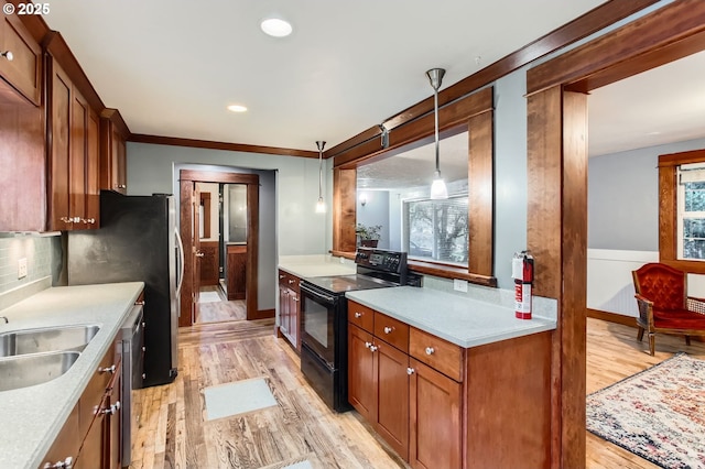 kitchen with light wood finished floors, light countertops, decorative backsplash, brown cabinetry, and electric range