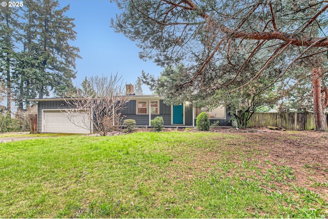 back of property featuring fence, a yard, board and batten siding, an attached garage, and a chimney